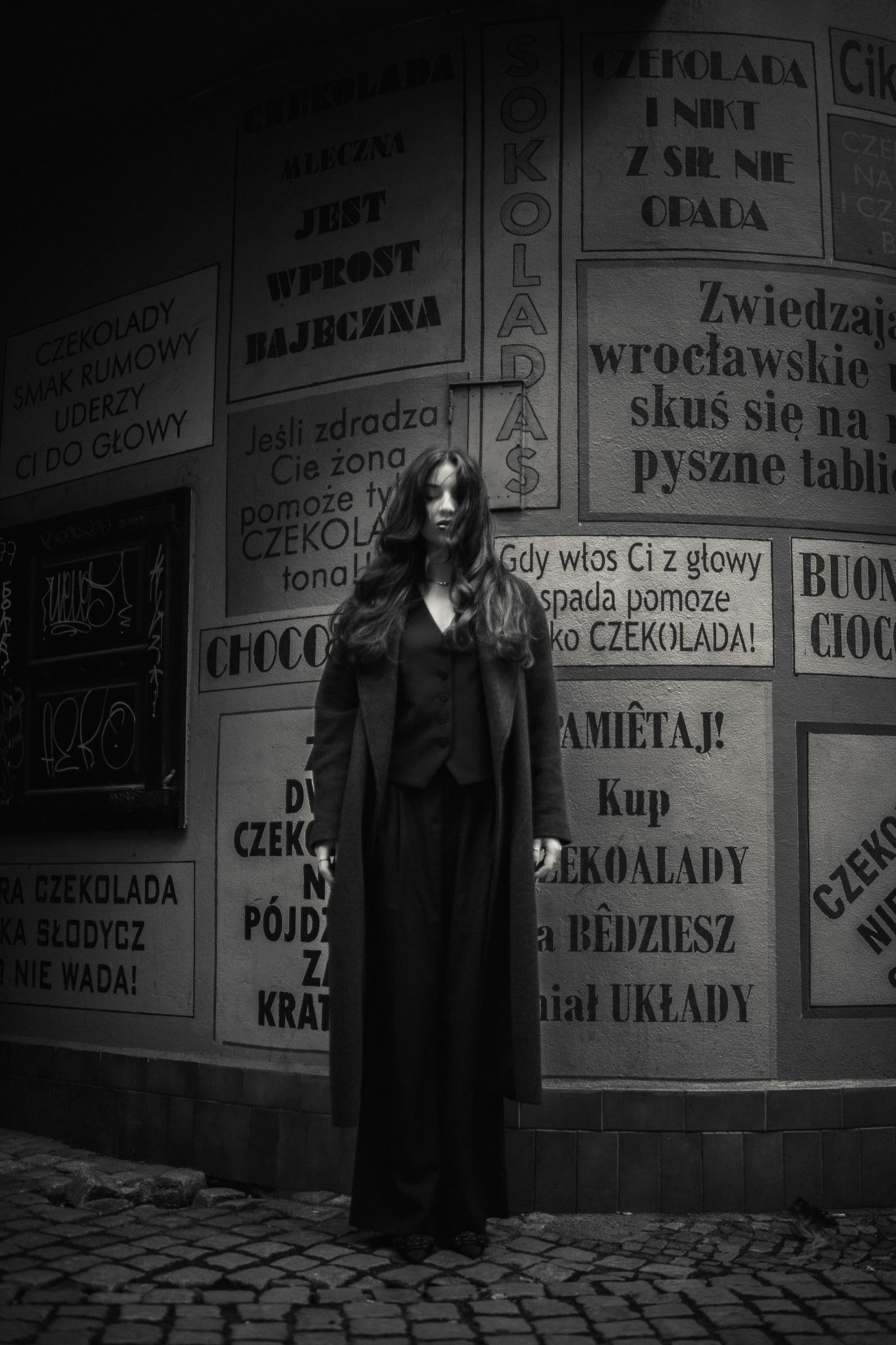 A young woman in black on a city street